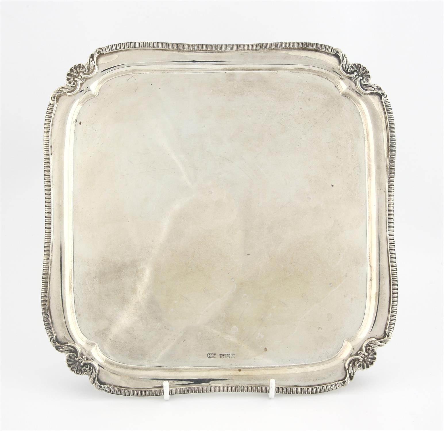 Square silver salver with shaped gadrooned border on scroll feet by Lee & Wigfull , Sheffield 1933,