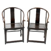 Pair of Chinese stained wooden horse shoe chairs