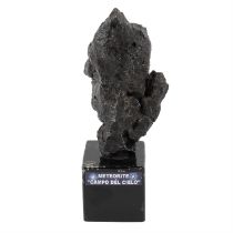 Metal sculpture upon a pedestal imitating a meteorite