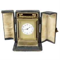 A small cased carriage clock