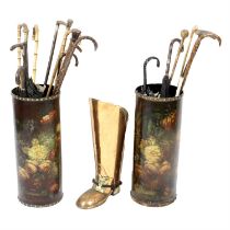 Assorted walking canes and umbrellas in three stick stands