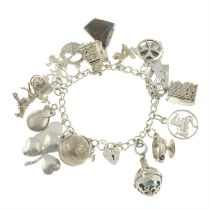 1970s silver charm bracelet, suspending a boulder opal charm, amongst others.