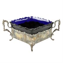 Late 19th century silver import dish with blue glass liner.