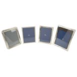 Four silver mounted photograph frames.