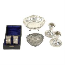Two silver pierced dishes, plus a cased pair of Edwardian silver napkin rings, and a pair of silver