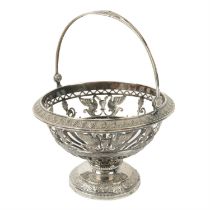 Continental pierced pedestal dish with swing handle.