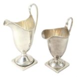 Two early 20th century silver pedestal cream jugs.