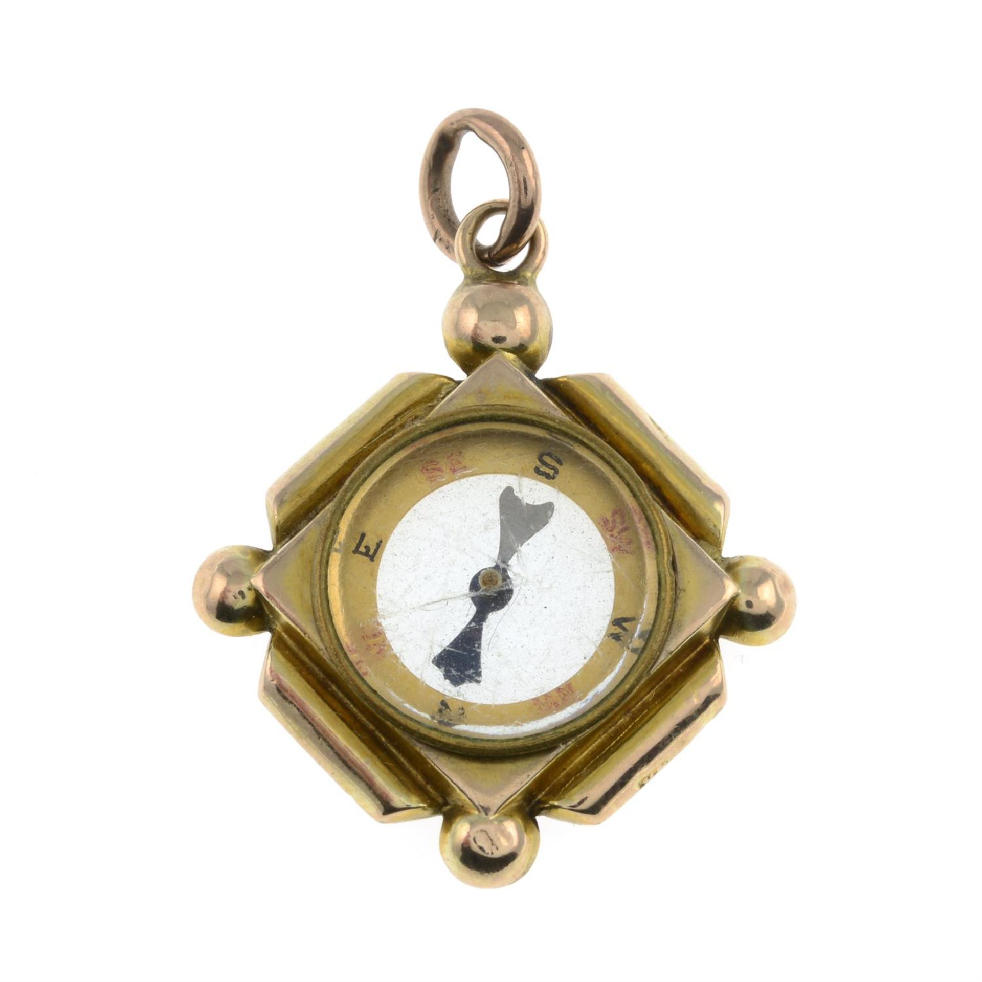 Early 20th century gold compass charm