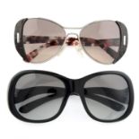 Prada - two pairs of sunglasses.