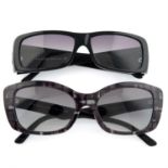 Prada - two pairs of sunglasses.