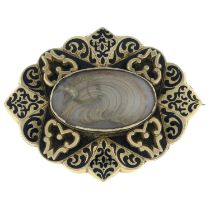 A Victorian enamel mourning brooch, with hairwork panel.