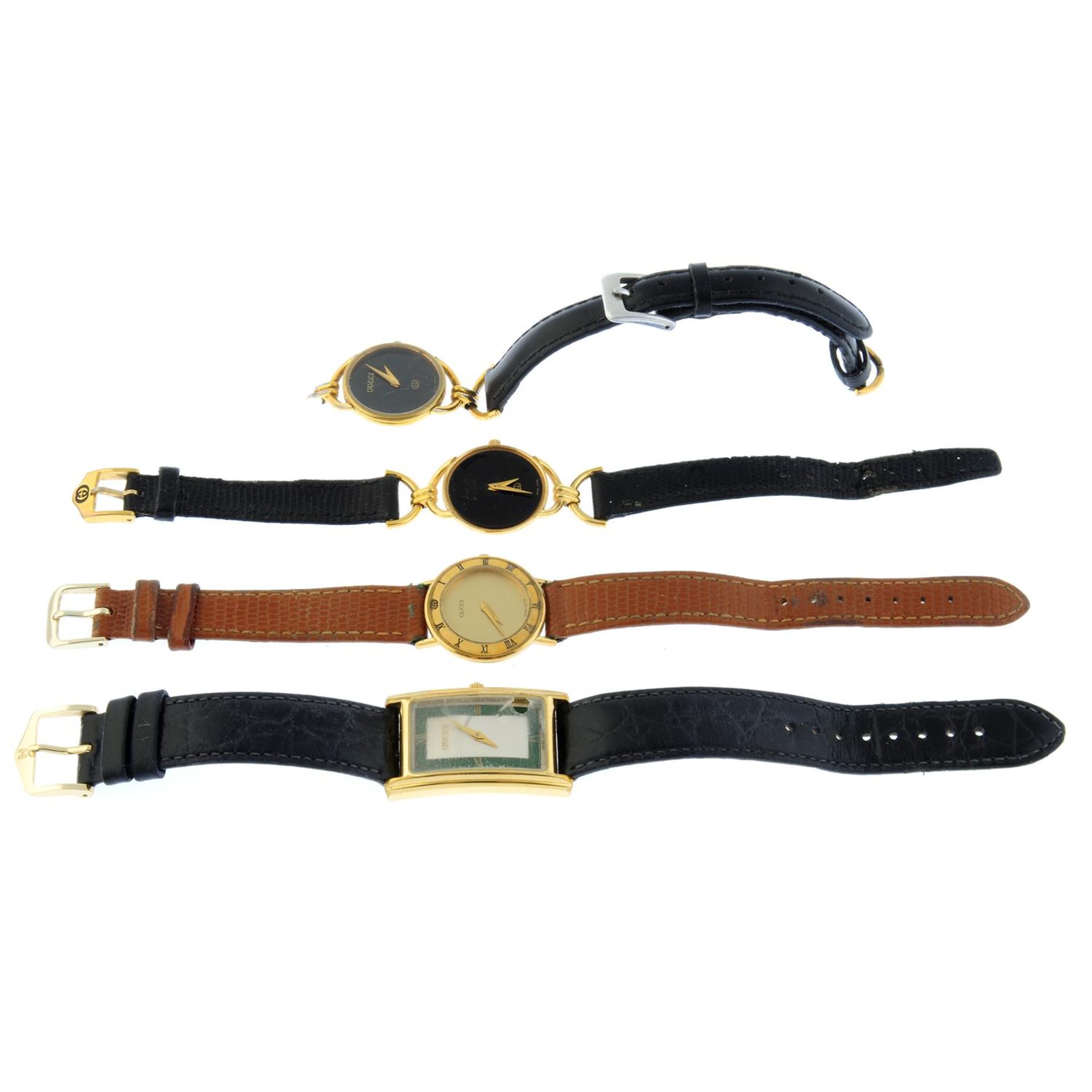 A group of four Gucci watches.