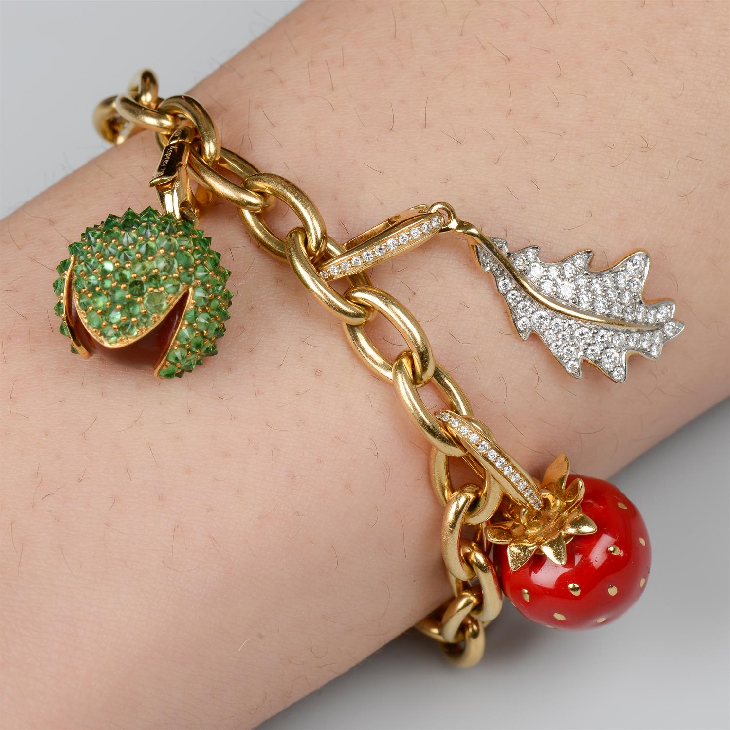 18ct gold bracelet and four charms, by Asprey