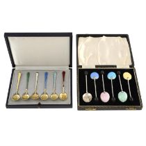 Two cased sets of silver & enamel coffee spoons.