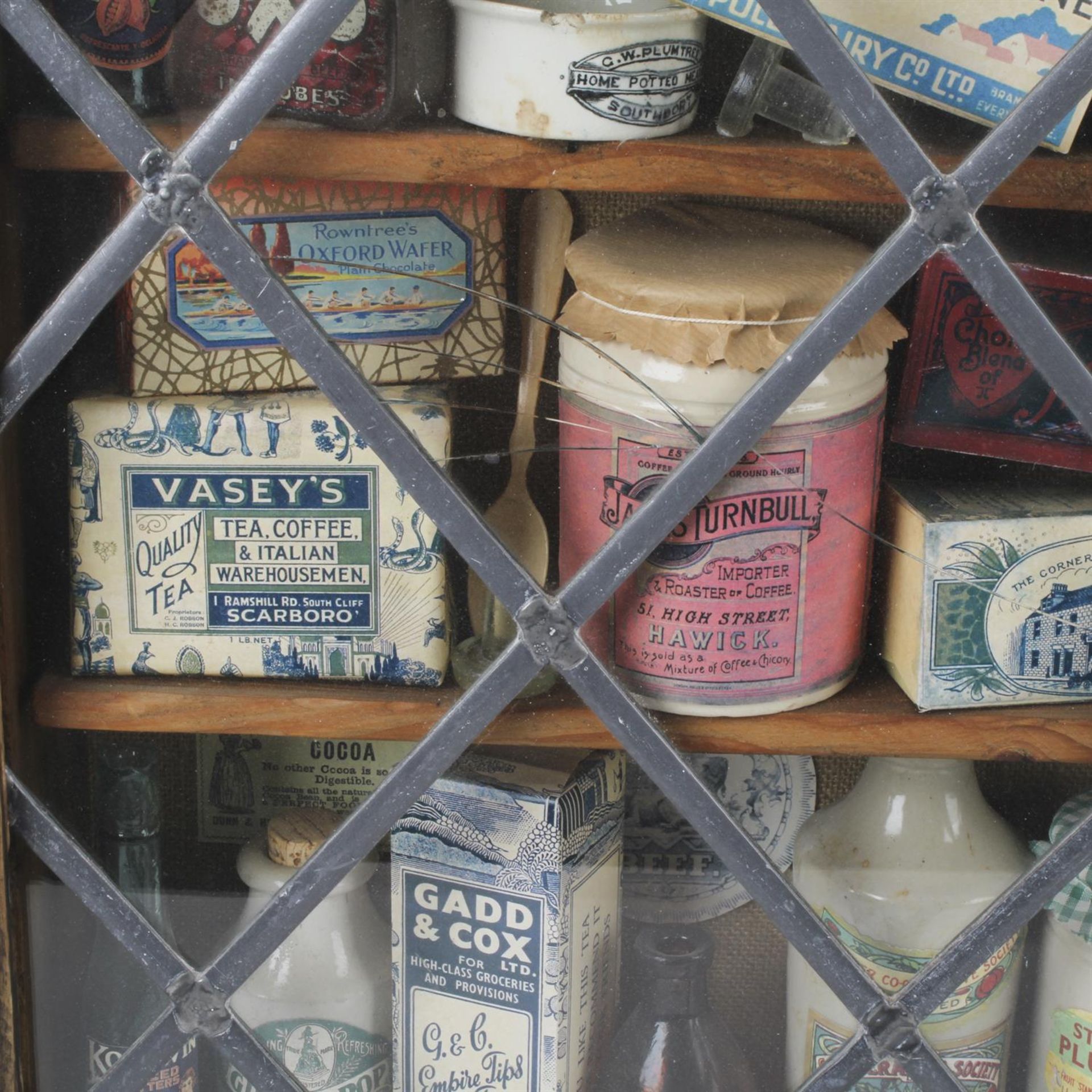 Display cabinet with vintage packaging contents - Image 2 of 3