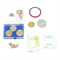 A group of assorted watch parts to include a Rolex style GMT bezel insert and five Rolex style