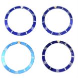 A group of four blue bezel inserts.