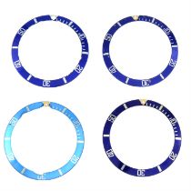 A group of four blue bezel inserts.