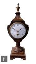 An Edwardian mahogany mantle clock in the Regency style, white circular dial with Arabic numerals,