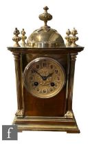 An early 20th Century brass mantle clock, eight day striking movement on a gong with Arabic dial