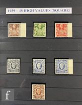 A blue stamp album containing a collection of George VI issues, including high values and booklets