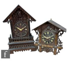 A late 19th Century carved walnut cased cuckoo clock of architectural form, on a plinth base, height