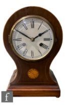 An Edwardian inlaid mahogany balloon shaped mantle clock, white dial inlaid with circular paterae,