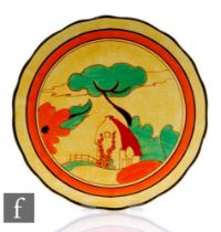 A Clarice Cliff Red Roofs Cafe Au Lait (Yellow) wave edged plaque circa 1931, hand painted with a