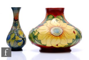 Two Moorcroft pottery vases, to include Inca Sunflower, height 17cm, and Hypericum, height 17cm. (2)