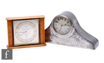 A 1930s Nelson hat type pewter hammered mantle clock and a post 1950s Kienzel mantle clock. (2)