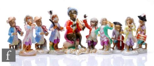 A group of 19th Century Monkey Band figures after Meissen, on scroll-moulded bases, to include a