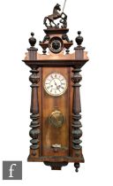 A 19th Century walnut cased Vienna wall clock the circular dial and spring driven movement