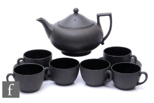 A Wedgwood black basalt tea service, comprising teapot, six teacups and two saucers, impressed