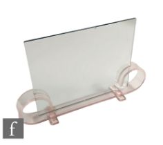 A 1930s Art Deco picture frame, the pale pink acrylic base with scroll ends fitted with two sheets