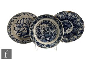 A collection of 18th/19th Century Dutch Delft chargers, all decorated with stylised floral designs