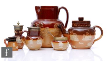 A collection of Doulton lambeth 'Harvest Wares' to include a three piece cruet, a small teapot, a