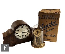 A Kundo Junior 400 day mantle clock in glass dome and original printed cardboard box and a walnut