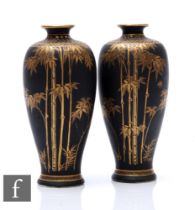 A pair of Japanese black satsuma vases, the all over black matte ground, picked out with gilt