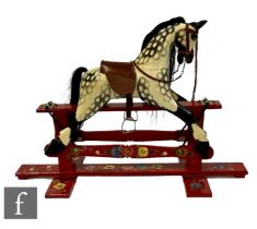 A late 20th Century painted pine rocking horse finished in a dappled grey finish, made by Roundhouse