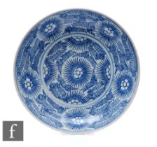 An early 19th Century 'Starburst' cargo dish, decorated with a series of swirling patterns in