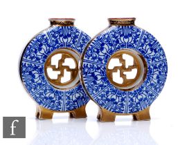 A pair of Royal Worcester 'Royal Lily' posy flasks, circa 1885, each of circular moonflask form,