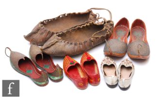 A collection of Indo/Persian leather shoes, to include an adult pair of shoes, and three children'