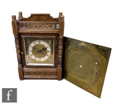 A late Victorian oak mantle clock, eight day striking movement, the square brass dial enclosed by