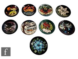 A collection of nine Moorcroft pottery pin dishes, to include Woodside, Gypsy, Bermuda Lily,