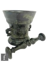 A small continental bronze pestle and mortar with bands of decoration with 'LOF GODT VAN AL 1662',