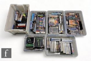 A large collection of assorted Sci-Fi and Action VHS tapes and DVDs, to include Alien, Space 1999,