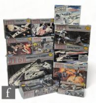 A collection of MPC / ERTL Star Wars plastic model kits, comprising Millennium Falcon, AT-ST, TIE