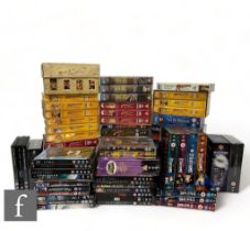 A collection of assorted VHS tapes and DVDs, to include Indiana Jones, Superman, Supergirl,