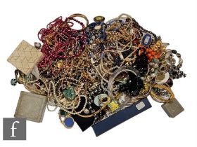 A parcel lot of assorted costume jewellery to include beads, brooches, pendants, bracelets,