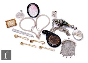 A small parcel lot of assorted items to include four gilt metal grips, two onyx mounted pendants,